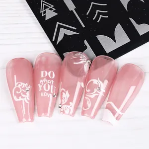 Detail of pink resin nail tips with floral prints and tiny rhinestones decoration