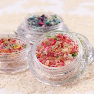 Assorted nail art dried flower petals in a crystal-cut jar for DIY manicure decoration