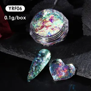 Macro shot of iridescent aurora chrome nail flakes and heart-shaped manicure sample