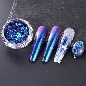 Macro shot of blue chameleon nail glitter flakes on long false nails in an octagonal jar