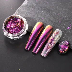 Macro shot of iridescent chameleon nail glitter in purple and gold tones on nails