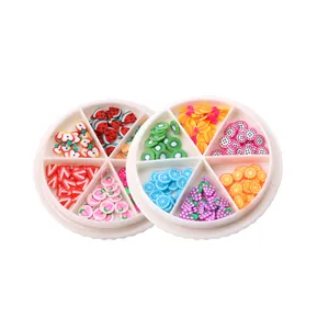 Fette di frutta colorate in pasta polimerica per nail art in contenitori a griglia