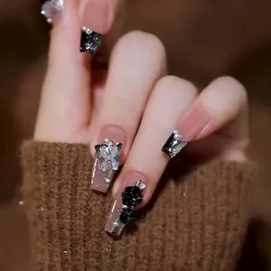 Detailed view of matte camellia 3D nail art with black roses and silver butterflies