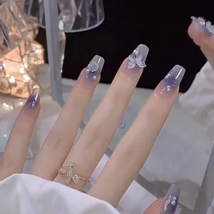 Detail of purple gradient coffin nails with 3D silver butterflies and rose charms