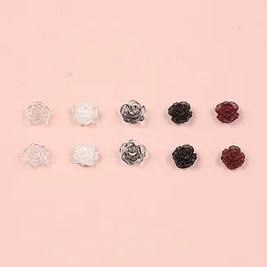 Detailed view of 3D matte resin rose charms for DIY nail art and jewelry in five colors