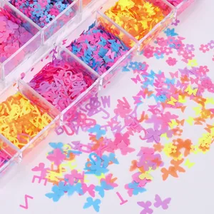 Macro shot of colorful butterfly and letter nail sequins in a transparent storage box