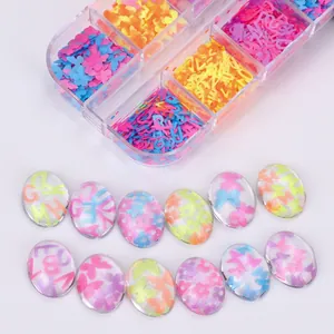 Macro view of colorful butterfly and letter sequins in a plastic organizer box