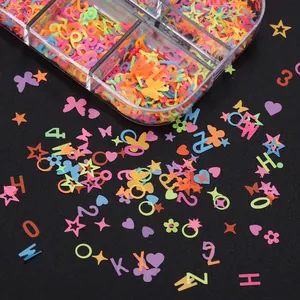 Macro shot of colorful neon nail sequins in star and heart shapes on black background