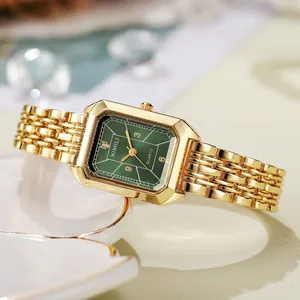 Close-up of a luxury square gold watch featuring a vintage emerald green sunburst dial