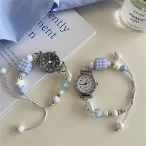 Detail of beaded quartz watch straps with light blue squares and white stars