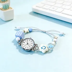 Women quartz watch with blue beads and adjustable drawstring strap on a desk scene