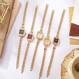 Flat lay of five vintage square dial watches with gold chain straps and rhinestone bezels