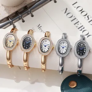Vintage oval quartz bangle watches with diamond bezel and minimalist Roman numeral dial