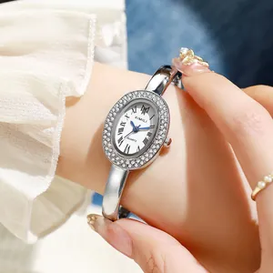 Retro oval silver wristwatch for women featuring a diamond bezel and white Roman numeral dial