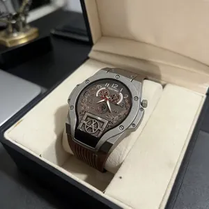 Detail of mechanical-style watch with hollow gear dial in a black display gift box