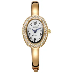 Elegant gold oval bangle watch for women with rhinestone bezel and Roman numerals dial