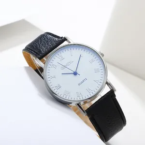 Macro shot of a classic watch dial with blue Roman numerals and black leather strap
