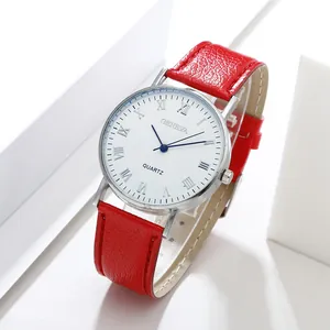 Macro detail of red leather strap and silver Roman numeral quartz watch dial