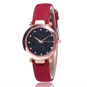 Elegant starry sky watch with rhinestones, faceted glass, and red suede strap on white background