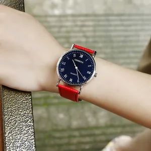 Close-up of Geneva quartz watch featuring blue Roman dial and red stitched leather strap