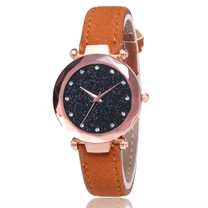 Detail of rose gold starry sky watch with sparkling rhinestones and brown leather strap