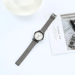 Minimalist quartz watch with grey mesh strap, white dial and striking blue hands