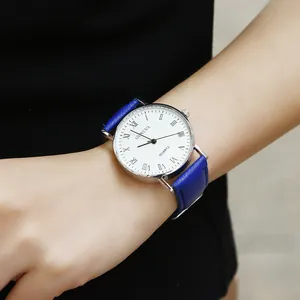 Close-up of Geneva quartz watch with blue leather strap and Roman numeral white dial