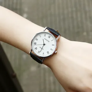Close-up of Geneva quartz watch with Roman numerals and black leather strap on wrist