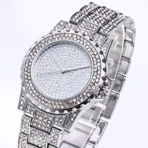Macro shot of silver rhinestone watch featuring a full diamond alloy band and dial