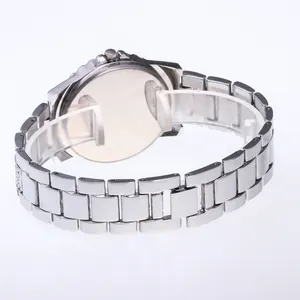 Detail of silver quartz watch featuring classic oyster steel band and polished case back
