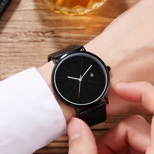 Men's minimalist black quartz watch with mesh strap and date window on wooden desk