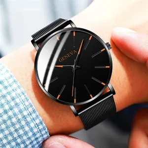 Close-up of minimalist black quartz watch with stainless steel mesh band on wrist