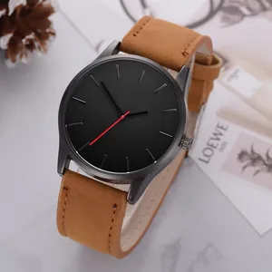 Detail of minimalist black dial watch with red second hand and brown suede leather strap