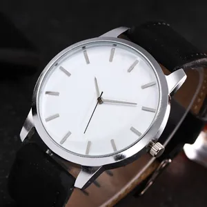 Macro shot of large white dial with silver markers and black matte strap on quartz watch