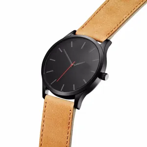 Detail of minimalist black dial watch with red second hand and khaki suede strap