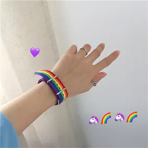 Bracelet de montre arc-en-ciel en nylon avec boucle argentée porté sur le poignet