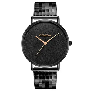 Detailed macro view of black minimalist watch dial with matte texture and gold mesh strap