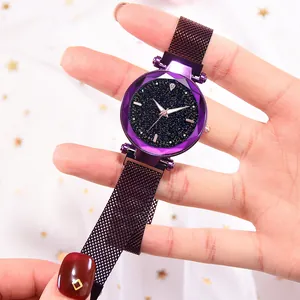 Detailed macro view of faceted glass crystal on star pattern dial women watch