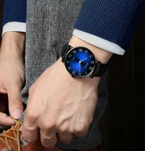 Close-up of Geneva men's quartz watch with blue sunray dial worn on suit sleeve