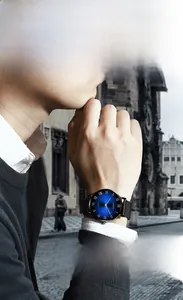 Macro shot of minimalist black mesh strap watch with blue sunray dial and Roman numerals
