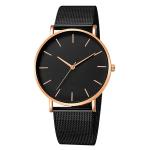 Detail of rose gold quartz watch with minimalist black dial and mesh steel strap