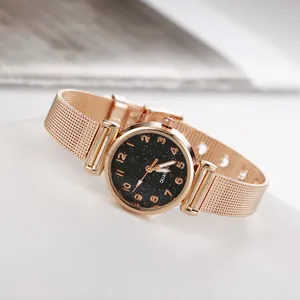 Dettaglio del cinturino in maglia oro rosa e quadrante stellato nero dell'orologio