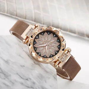 Detailed macro view of the rose gold Milanese strap and rhinestone flower watch face