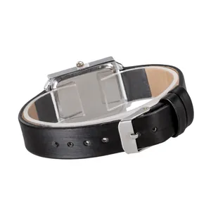 Detail of the black textured leather strap and silver rectangular watch case on stand