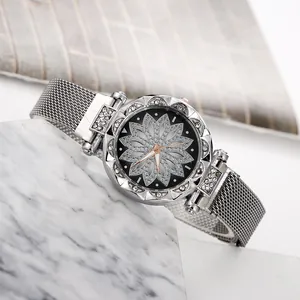 Detailed shot of silver Milanese mesh strap watch with sparkling crystal flower dial