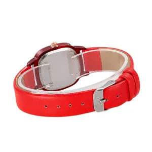 Detail of red leather watch strap with visible stitching and classic metal buckle