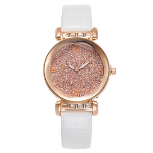 Detail of rose gold watch case with crystal inlay and white crocodile embossed leather strap