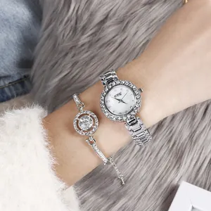 Elegant silver watch and rhinestone bracelet set on a stylish plush background