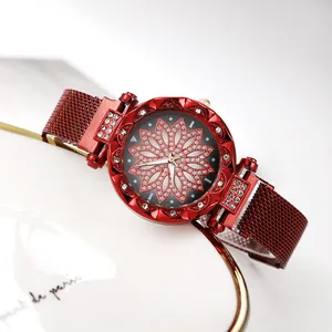 Macro shot of red Milanese loop watch featuring a sparkling diamond-set flower dial