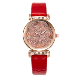 Detail of red crocodile leather strap and rose gold crystal encrusted dial watch